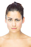 Front view of sceptical woman looking at camera