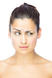 Front view of beautiful sceptical woman looking away