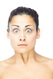 Front view of shocked brunette woman looking at camera