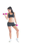 Beautiful sporty woman training with dumbbells