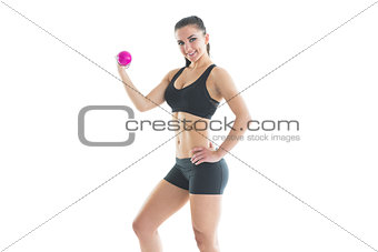 Sporty fit woman posing with pink hand weight