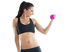 Cheerful slender woman training her arm using a pink dumbbell