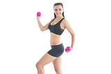 Pretty fit woman training with pink dumbbells