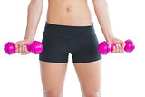 Close up of slender woman training with pink dumbbells