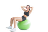 Gorgeous active woman practicing an exercise on an exercise ball
