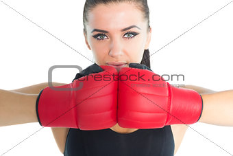 Gorgeous sporty woman posing wearing boxing gloves