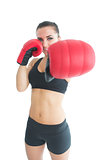 Beautiful sporty woman posing wearing red boxing gloves