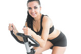 Attractive sporty woman exercising with an exercise bike