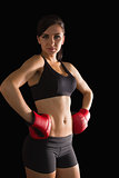 Beautiful sporty woman posing wearing boxing gloves