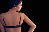 Rear view of gorgeous young woman wearing dark lingerie