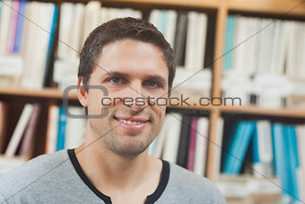 Handsome man posing in library