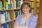 Mature intellectual woman posing in library
