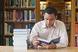 Intellectual attractive man reading concentrated a book