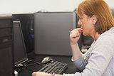 Unsure female mature student working on computer