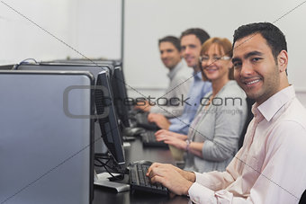 Computer class sitting in front of computers