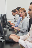 Female mature student sitting in computer class