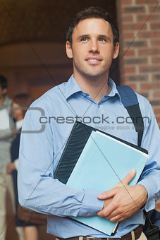 Handsome male mature student posing holding some files