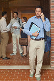 Attractive mature student phoning with his smartphone
