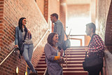 Casual students standing on stairs chatting