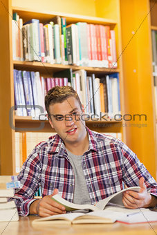 Handsome happy student studying his books
