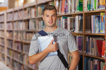 Handsome smiling student holding tablet