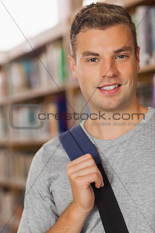 Handsome smiling student looking at camera