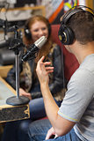 Attractive smiling radio host interviewing a guest