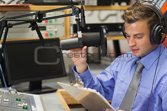 Well dressed focused radio host moderating