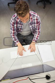 Handsome focused student working on computer