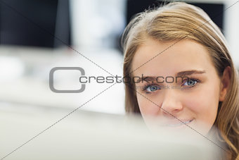 Cheerful pretty student working on computer