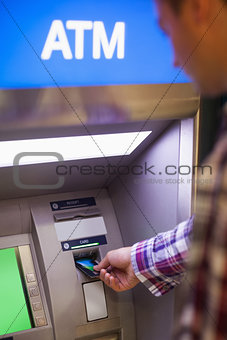 Casual student withdrawing cash