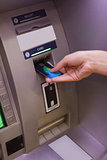 Close up of hand pulling in debit card