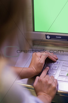 Woman entering pin and covering keyboard