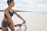 Content young woman riding her bike on the beach