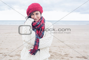 Cute smiling young woman in stylish warm clothing