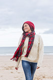 Woman in stylish warm clothing at beach
