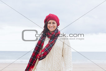 Pretty woman in stylish warm wear at beach