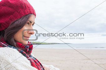 Woman in knitted hat and pullover at beach