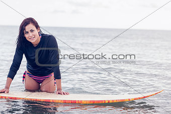 Beautiful young woman with surfboard in water