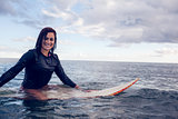 Portrait of a beautiful woman with surfboard in water