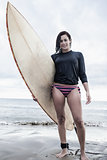 Full length of a woman with surfboard at beach