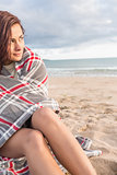 Beautiful  woman covered with blanket at beach