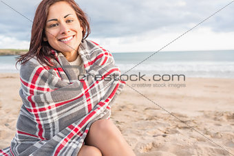 Portrait of a woman covered with blanket at beach
