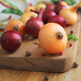 Red and yellow onions on the cutting board