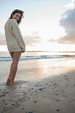 Full length of a woman in sweater standing on beach