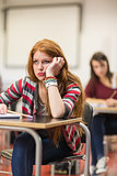 Bored female student sitting in classroom
