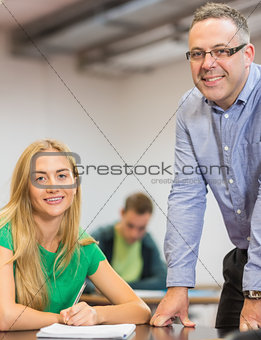 Smiling teacher and student in classroom
