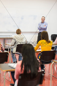 Attentive students with teacher in the classroom