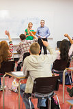 Students raising hands in the classroom
