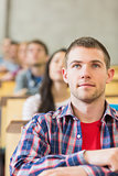Close up of a male student with others in classroom